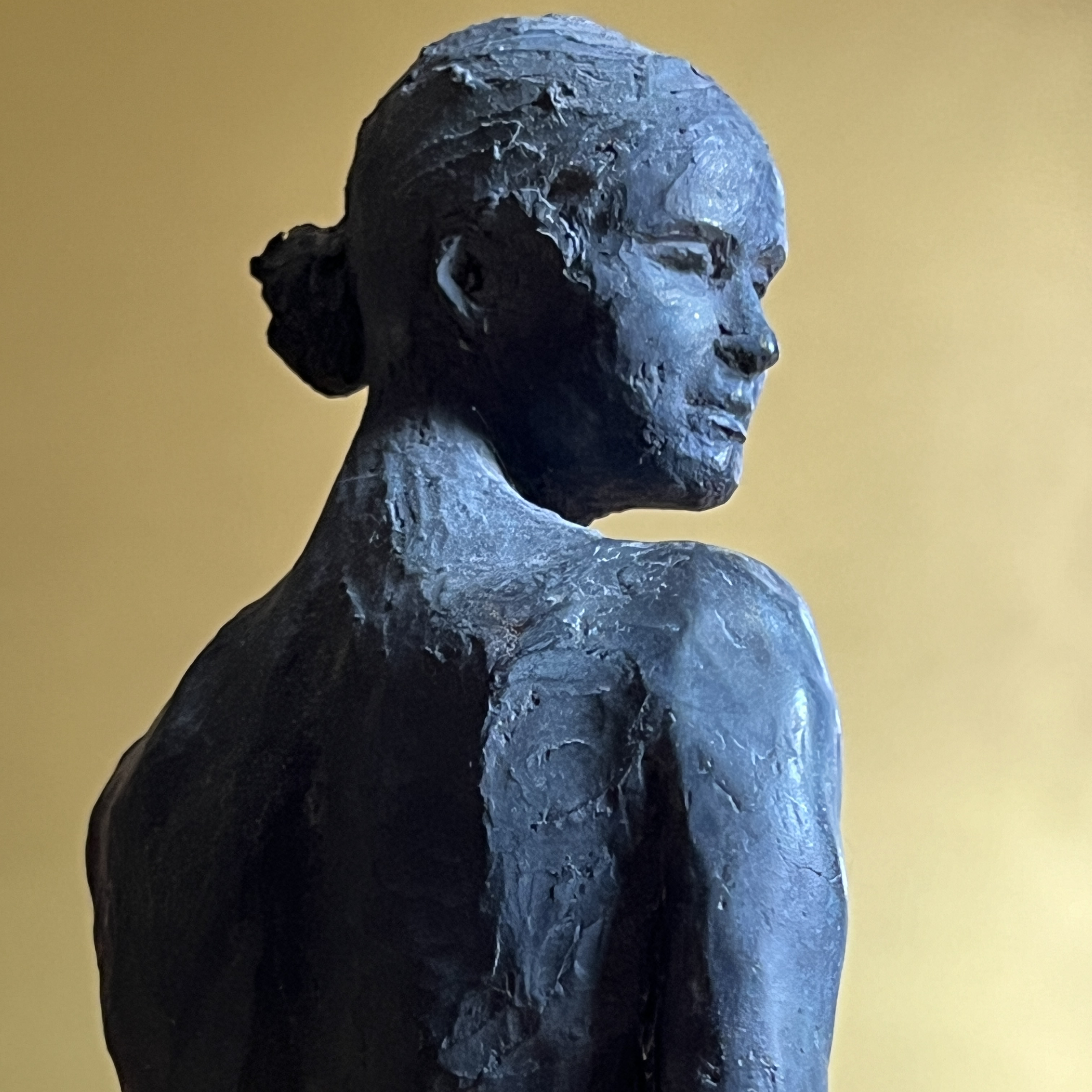 Sculpture of graceful woman's head with patina